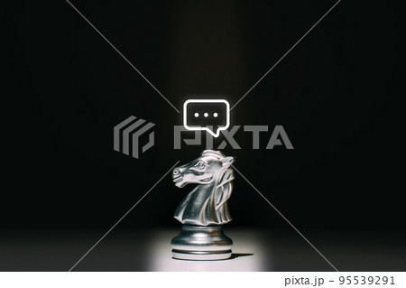 A chess piece of a horse with a message icon above it. Concept of communication and HR. A chess piece of a horse with a message icon above it. Concept of communication and HR. 95539291