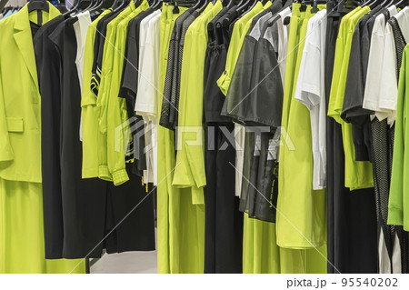Collection of female clothes on hangers in store. Fashion show room. Shopping background Collection of female clothes on hangers in store. Fashion show room. Shopping background 95540202