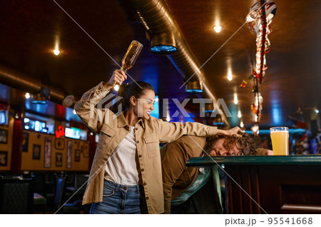 Unhappy and angry fans fighting at sport bar Unhappy and angry fans fighting at sport bar 95541668