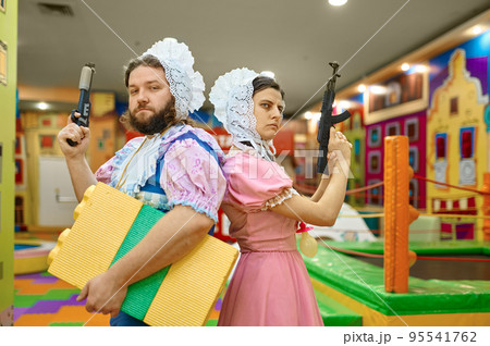 Man and woman like baby gangsters with guns Man and woman like baby gangsters with guns 95541762