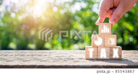 Tax concept for business, Person hand holding wooden block with tax icon on Vr screen, Data analysis, paperwork, financial research, report, Calculation tax. Tax concept for business, Person hand holding wooden block with tax icon on Vr screen, Data analysis, paperwork, financial research, report, Calculation tax. 95543867