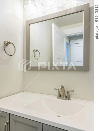 Vertical Single vanity sink in a small white bathroom with towel ring holder Vertical Single vanity sink in a small white bathroom with towel ring holder 95545812
