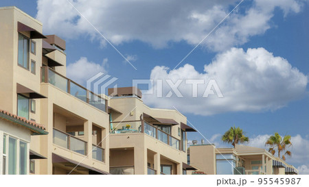 Panorama White puffy clouds Residential buildings with glass railings at La Jolla, Californi 95545987