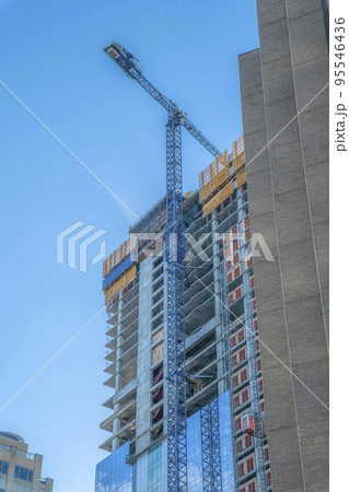 Construction crane in front of an unfinished building in downtown Austin Texas 95546436