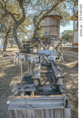 Small vinatge wood water storage tank with metal pipe and wooden waterway 95546480