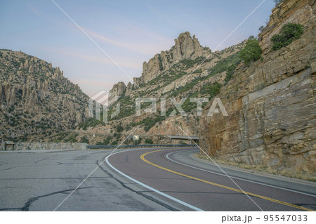 Winding road in scenic Mount Lemmon with cliffs and sky view in Arizona 95547033