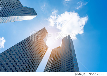Low angle view of skyscrapers modern office building city in business center with blue sky 95547896