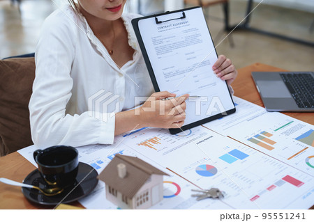 Portrait of a beautiful bank young woman sign credit department of signing approval for a home loan. 95551241