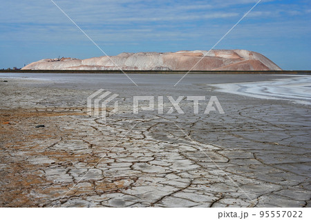 Potash waste heaps with toxic lake and dried up earth 95557022