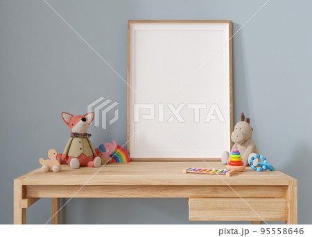 Empty vertical picture frame standing on the desk in modern child room. Frame mock up in contemporary style. Free, copy space for picture, poster. Plush and wooden toys. Close up view. 3D rendering. Empty vertical picture frame standing on the desk in modern child room. Frame mock up in contemporary style. Free, copy space for picture, poster. Plush and wooden toys. Close up view. 3D rendering. 95558646