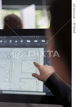 Real estate agent planning room floor in software, drafting, home interior wireframes on computer monitor screen. Asian employee in architecture office, creating project blueprints. 95559520
