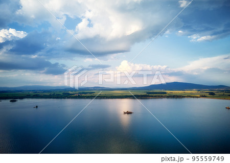 Aerial top view of beautiful landscape with large lake against mountains shapes at summer day. Mietkow lake near Wroclaw, Poland Aerial top view of beautiful landscape with large lake against mountains shapes at summer day. Mietkow lake near Wroclaw, Poland 95559749