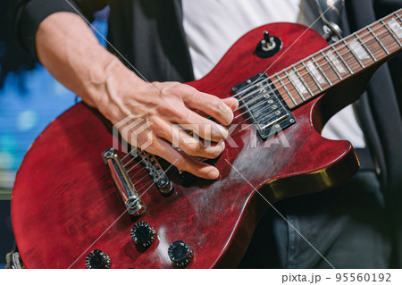 Guitarist Playing Electric Guitar live on stage. Close-up. Guitarist Playing Electric Guitar live on stage. Close-up. 95560192