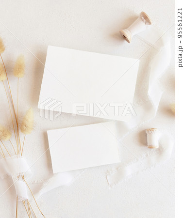 Blank cards near silk ribbons and dried hare's tail grass top view on white, boho mockup Blank cards near silk ribbons and dried hare's tail grass top view on white, boho mockup 95561221
