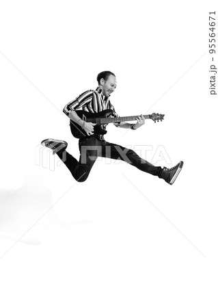 Portrait of young emotive man in stylish clothes playing guitar, posing isolated over white background. Black and white photo Portrait of young emotive man in stylish clothes playing guitar, posing isolated over white background. Black and white photo 95564671