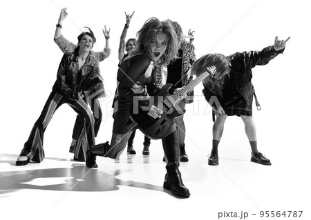 Group of stylish people, man and woman, rock musicians performerming over white background. Black and white photography. Concert Group of stylish people, man and woman, rock musicians performerming over white background. Black and white photography. Concert 95564787