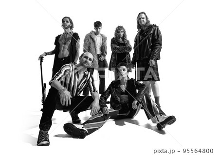 Group of stylish expressive people, man and woman, rock music performers posing over white background. Black and white photography Group of stylish expressive people, man and woman, rock music performers posing over white background. Black and white photography 95564800