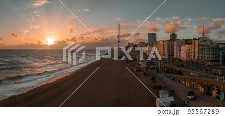 Beautiful Brighton beach view. Magical sunset and stormy weather in Brighton, UK. Town by the ocean in England. 95567289