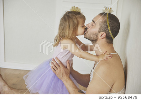 Father and daughter play dressed up as princesses Father and daughter play dressed up as princesses 95568479