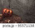 Glittering Halloween pumpkin in autumn leaves on wooden background. Seasonal photo with space for your text 95571138