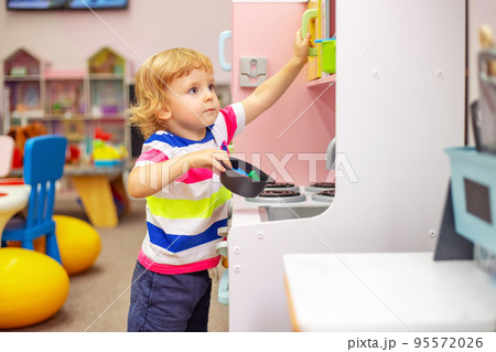 Child playing with colorful toys at the learning center or in kindergarten Child playing with colorful toys at the learning center or in kindergarten 95572026