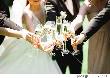 Party with friends. Group of cheerful young people carrying sparklers and champagne flutes Party with friends. Group of cheerful young people carrying sparklers and champagne flutes 95572331