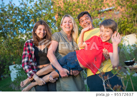 Portrait of amusing family at backyard Portrait of amusing family at backyard 95572637