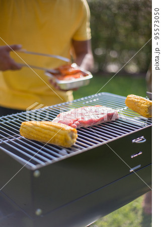 Close-up of steak and corn on BBQ Close-up of steak and corn on BBQ 95573050
