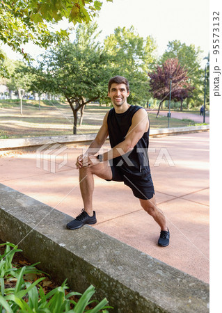 Happy man exercising in park 95573132