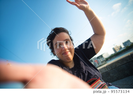 Happy Caucasian woman having walk on summer day Happy Caucasian woman having walk on summer day 95573134