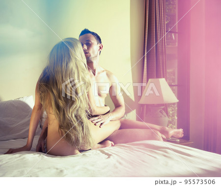 Two lovers in home interior. Nude couple in bedroom Two lovers in home interior. Nude couple in bedroom 95573506