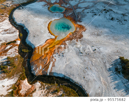 Beautiful geysers with hot water and steam with pools of thermophilic bacteria in the Upper Geyser Basin of Yellowstone National Park, Wyoming, United States. 95575682