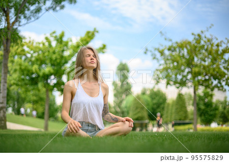 Girl practice yoga meditation outdoor in park 95575829