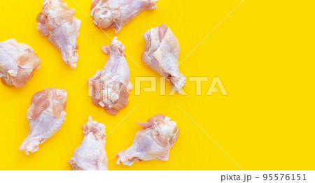 Fresh raw chicken wings (wingstick) on yellow background. Fresh raw chicken wings (wingstick) on yellow background. 95576151
