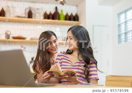 lgbtq, lgbt concept, homosexuality, portrait of two Asian women posing happy together and showing love for each other while being together. lgbtq, lgbt concept, homosexuality, portrait of two Asian women posing happy together and showing love for each other while being together. 95578596