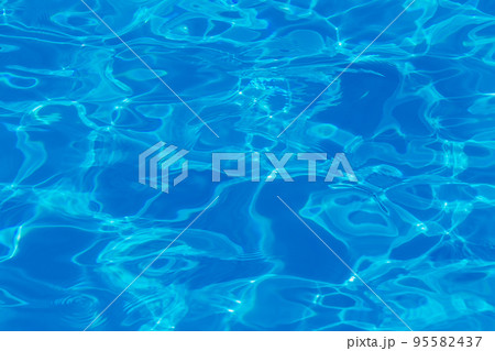Swimming pool water surface with sparkling light reflections Swimming pool water surface with sparkling light reflections 95582437