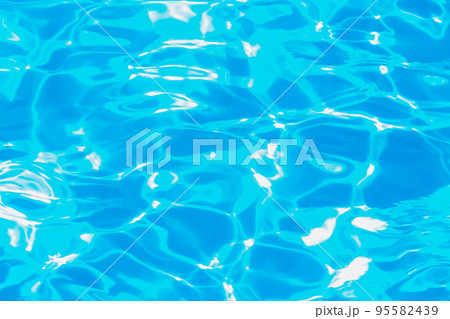 Swimming pool water surface with sparkling light reflections Swimming pool water surface with sparkling light reflections 95582439