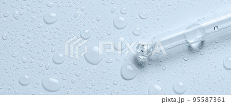 Micellar water drops and pipette. Cosmetic product for moisturizing the skin or removing makeup. Close-up, macro photography 95587361