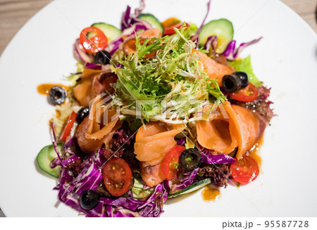 Traditional Caesar salad with hot smoked salmon 95587728