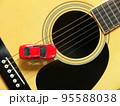 フォークギターとミニチュアの赤いスポーツカー 95588038