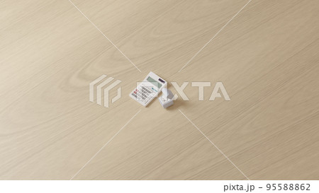 平面上に置かれた2つの結婚指輪を収めたケースと白い電卓の3Dレンダリングイラスト 平面上に置かれた2つの結婚指輪を収めたケースと白い電卓の3Dレンダリングイラスト 95588862