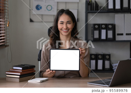 Business woman holding digital tablet show something on display at office. Blank screen for your advertising Business woman holding digital tablet show something on display at office. Blank screen for your advertising 95589976
