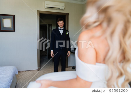 first meeting. gentle and in love blonde bride and groom in the room  95591200