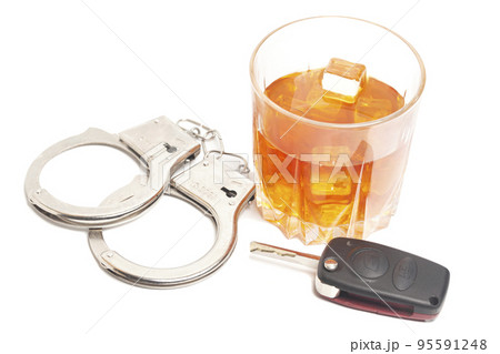 Concept for drinking and driving. Whiskey with car keys and handcuffs. Concept for drinking and driving. Whiskey with car keys and handcuffs. 95591248