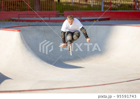 One man, male roller skater on rollerblades training at modern skate park, outdoors. Action, motion, skills and challenges. Doing different tricks One man, male roller skater on rollerblades training at modern skate park, outdoors. Action, motion, skills and challenges. Doing different tricks 95591743