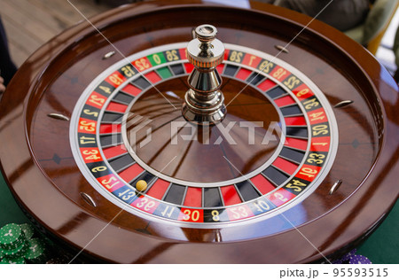 A close up of a blackjack dealer's hands in a casino, very shallow depth of field. A close up of a blackjack dealer's hands in a casino, very shallow depth of field. 95593515