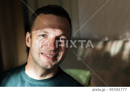 Close up face portrait of smiling young adult man 95593777