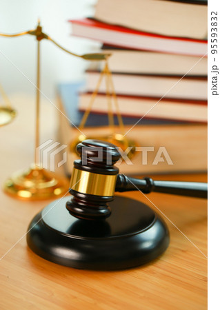 Lawyer or judge's hammer in the court. Auction's hammer and judgement golden scale are on wood table. Law subject. Judgement subject to judge people. 95593832