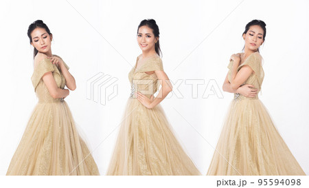 Princess wear Gold glitter Evening Gown ball dress and fashion vintage poses beautiful. 20s Asian woman dream to be princess and feel happy smile over white background isolated 95594098