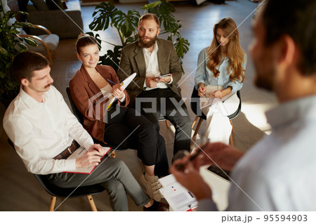 Group of young people, businessmen at business meeting at office space. Scientific conference event, training, brainstorm. 95594903